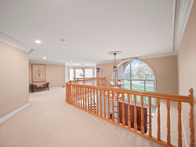 corridor featuring crown molding, light colored carpet, and an inviting chandelier