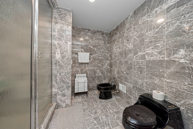 bathroom featuring a bidet, a shower with door, toilet, and tile walls