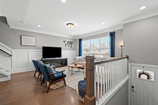 living room with dark hardwood / wood-style flooring and crown molding