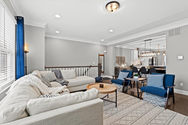 living room with ornamental molding and wood-type flooring