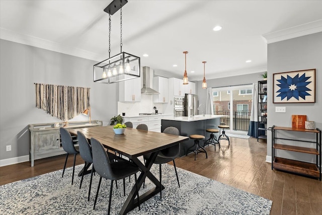 dining space with dark hardwood / wood-style flooring and crown molding