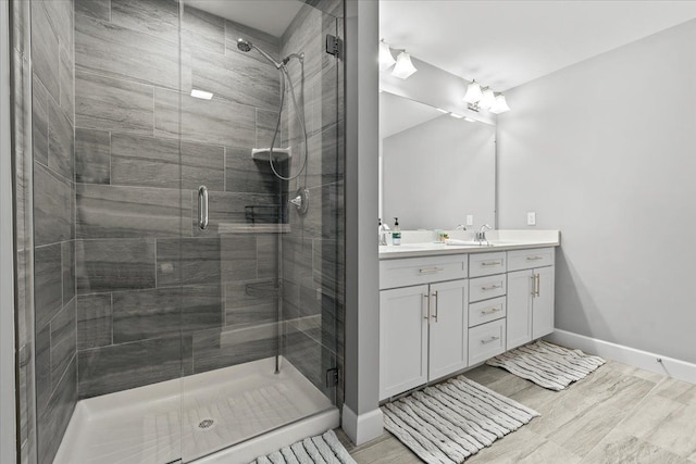 bathroom featuring an enclosed shower and vanity