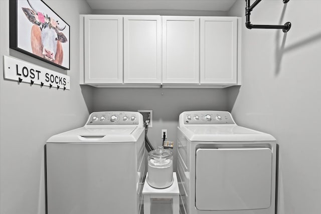 laundry room with cabinets and washer and clothes dryer