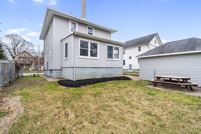 rear view of property with a yard