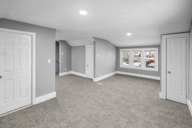 basement with carpet flooring and a textured ceiling