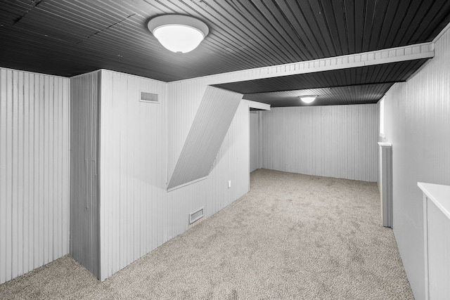 basement featuring light colored carpet