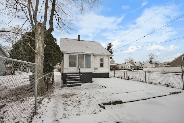 view of snow covered rear of property