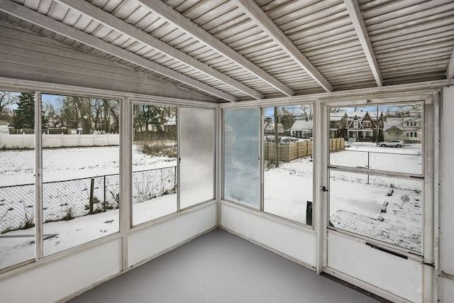 unfurnished sunroom featuring vaulted ceiling