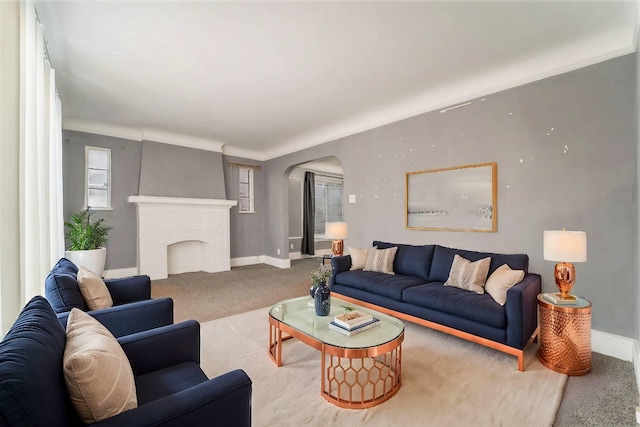 living room featuring carpet floors and a brick fireplace