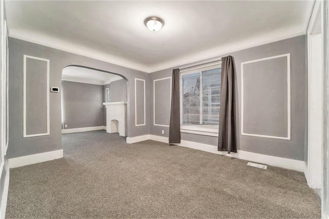 carpeted empty room with crown molding