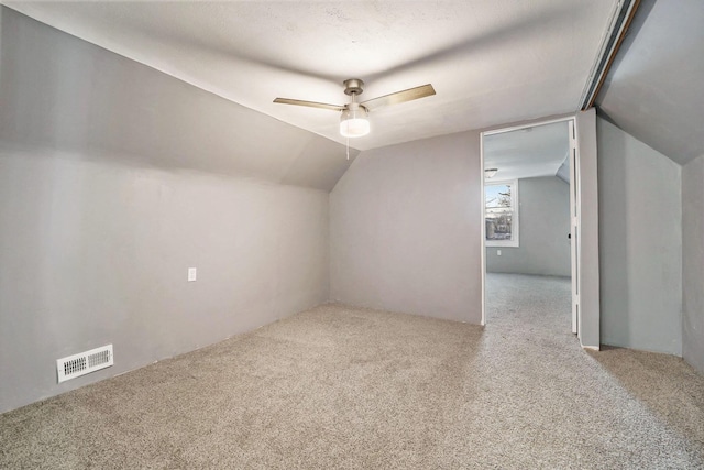 bonus room featuring carpet flooring, ceiling fan, a textured ceiling, and vaulted ceiling