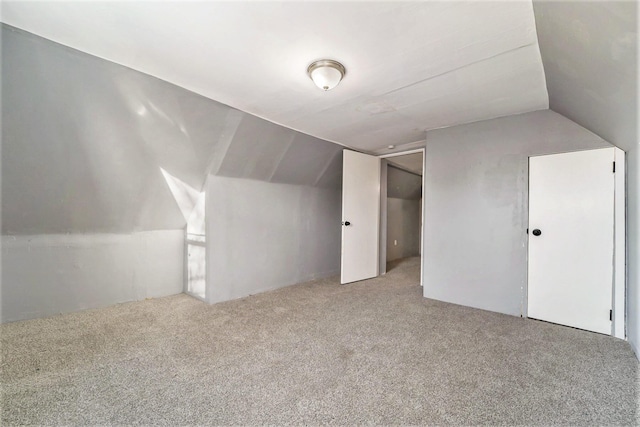 bonus room with carpet floors and lofted ceiling