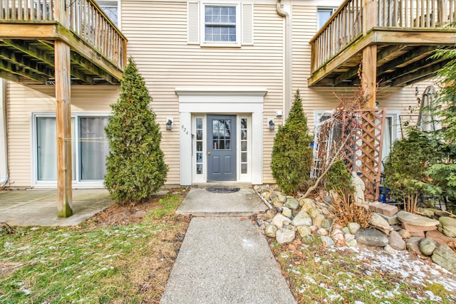 view of exterior entry with a patio