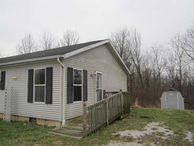 view of property exterior with a deck and a storage shed