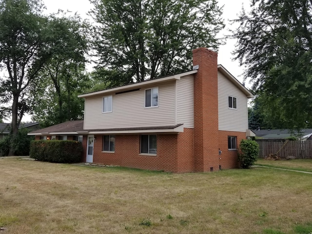 back of house with a lawn