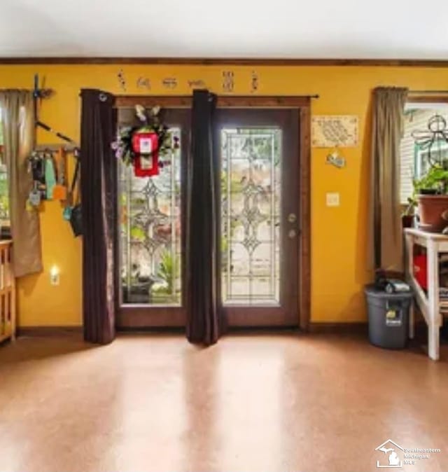 interior space with ornamental molding and a healthy amount of sunlight