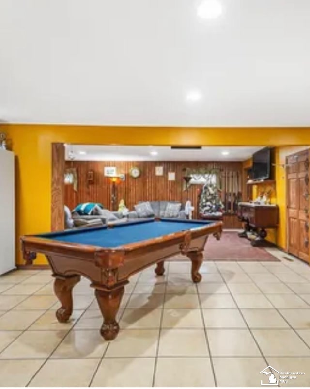 recreation room with wooden walls, light tile patterned floors, and pool table