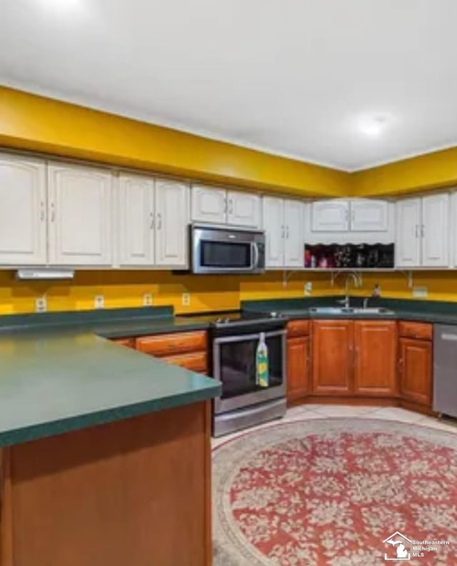 kitchen with white cabinetry, sink, and appliances with stainless steel finishes