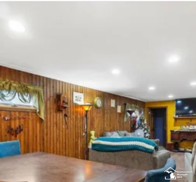 dining room featuring wooden walls