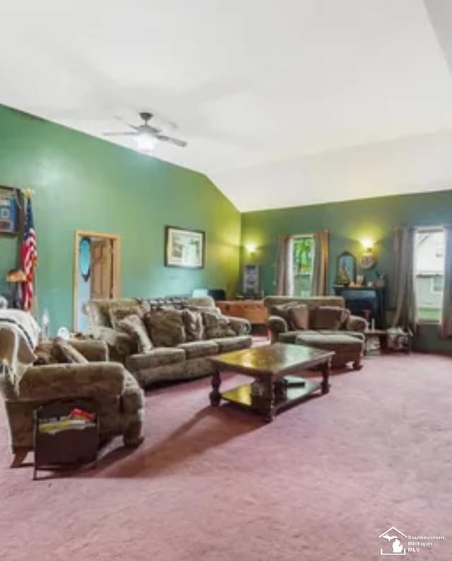 carpeted living room with vaulted ceiling, ceiling fan, and a healthy amount of sunlight