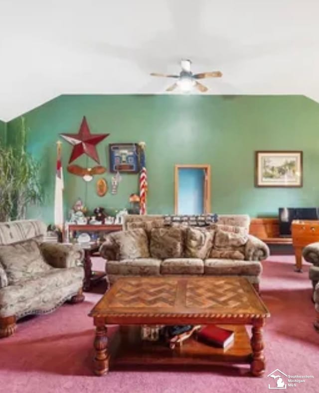 carpeted living room with ceiling fan and lofted ceiling