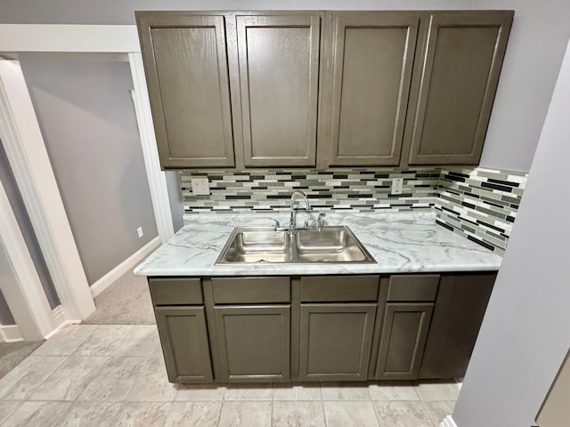 kitchen featuring decorative backsplash, light carpet, and sink