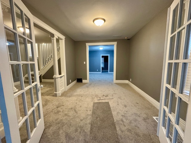 corridor with french doors and carpet floors