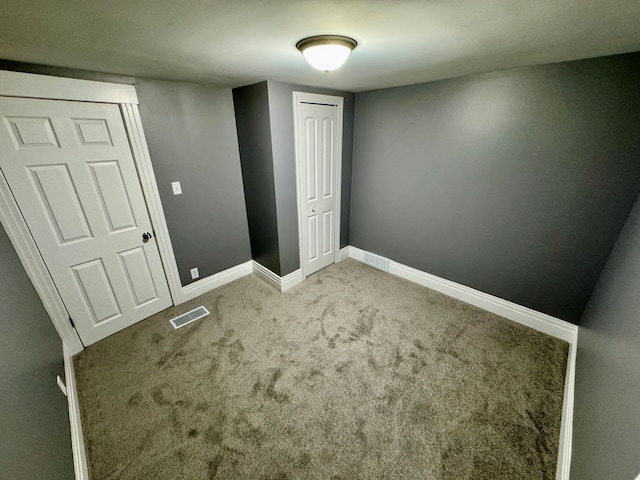 unfurnished bedroom with carpet and a closet