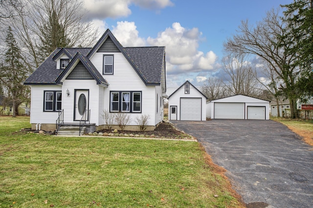 view of front facade with an outbuilding, a garage, and a front yard