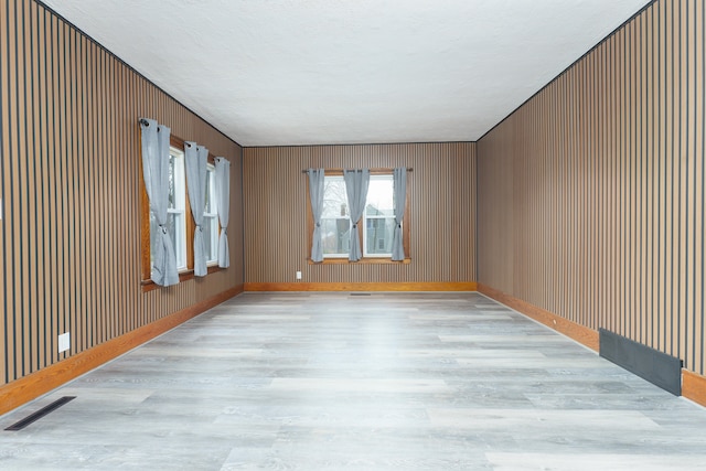 spare room with light hardwood / wood-style flooring