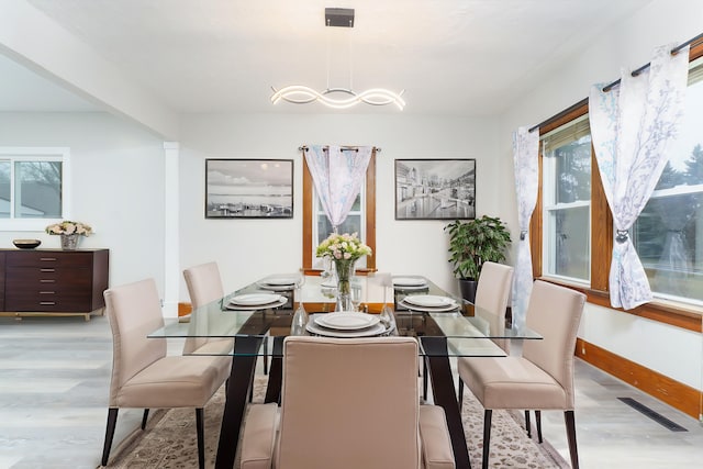 dining area with a healthy amount of sunlight and light hardwood / wood-style floors