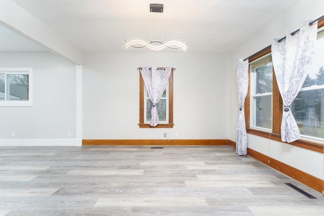 unfurnished room with light wood-type flooring