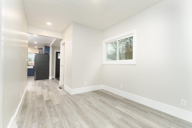 unfurnished room featuring a healthy amount of sunlight and light hardwood / wood-style floors