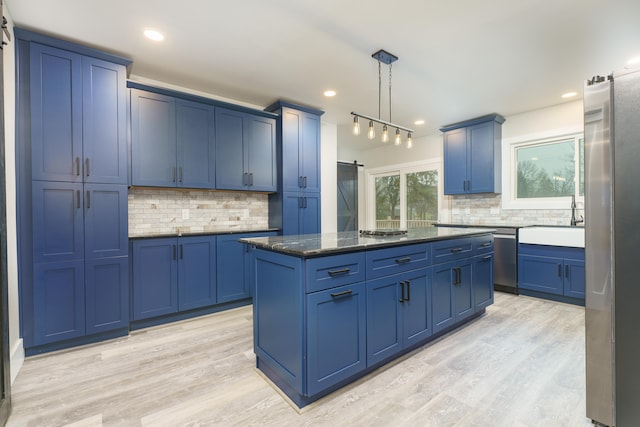 kitchen with blue cabinetry, pendant lighting, and a center island