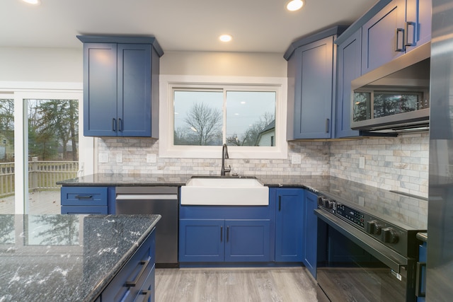 kitchen with blue cabinetry, light wood-type flooring, sink, and stainless steel appliances