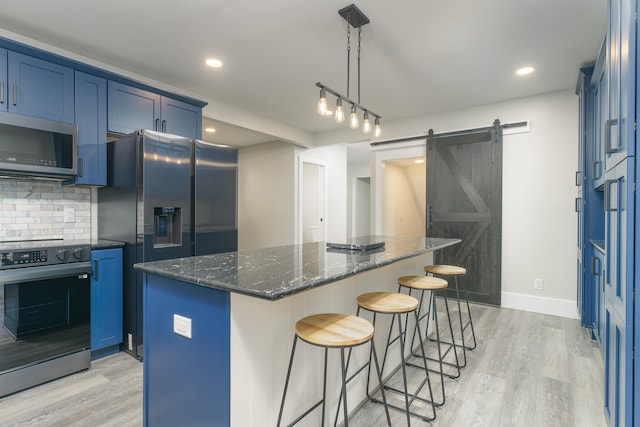 kitchen with a barn door, a kitchen island, blue cabinets, and electric range