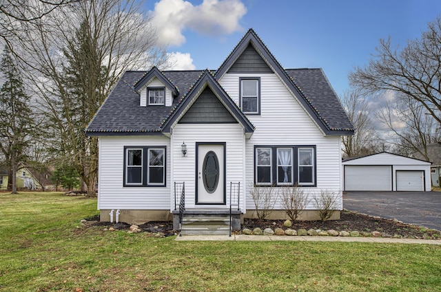 view of front of property featuring a front lawn, an outdoor structure, and a garage