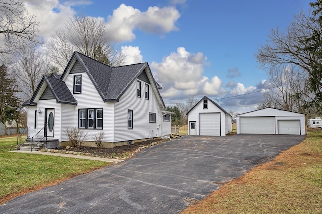 view of side of home featuring a lawn, a garage, and an outdoor structure