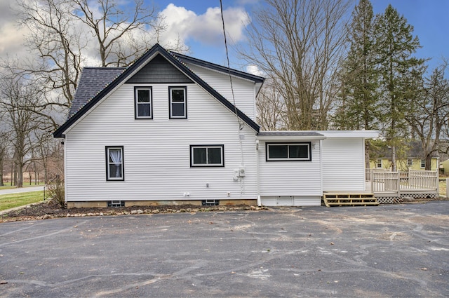 view of property exterior featuring a wooden deck