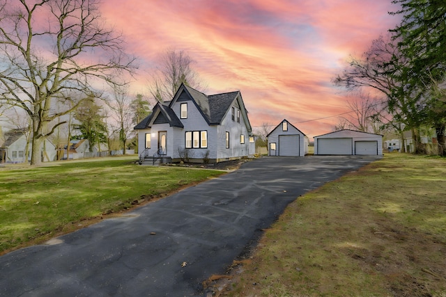 4981 W Liberty Rd, Ann Arbor, MI 48103 - view of front of property featuring a garage, an outbuilding, and a lawn