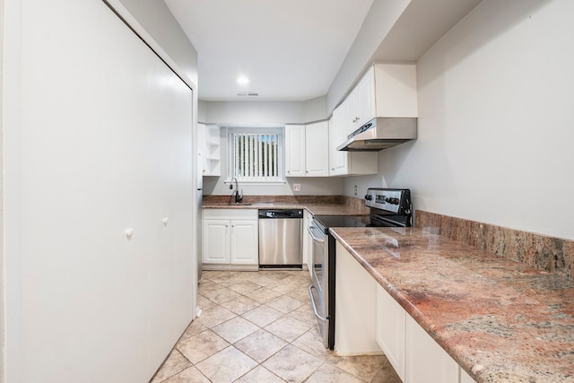 kitchen featuring white cabinets, appliances with stainless steel finishes, light tile patterned floors, and sink