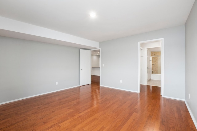 unfurnished room with hardwood / wood-style flooring