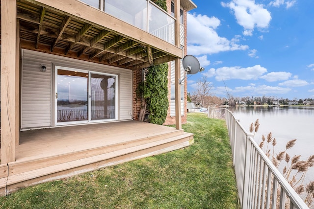 wooden terrace featuring a yard and a water view