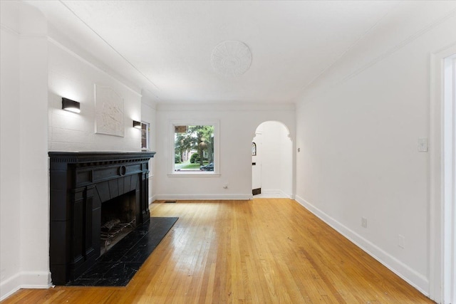 living room featuring wood-type flooring and crown molding