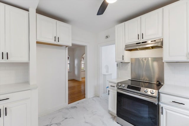 kitchen with tasteful backsplash, ceiling fan, white cabinets, and stainless steel electric range