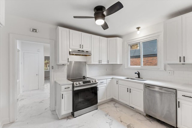 kitchen featuring sink, ceiling fan, appliances with stainless steel finishes, tasteful backsplash, and white cabinetry