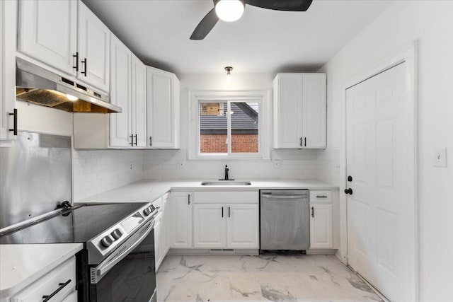 kitchen featuring sink, white cabinetry, stainless steel appliances, and tasteful backsplash