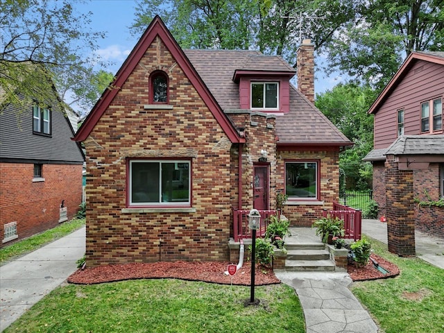 tudor home with a front yard