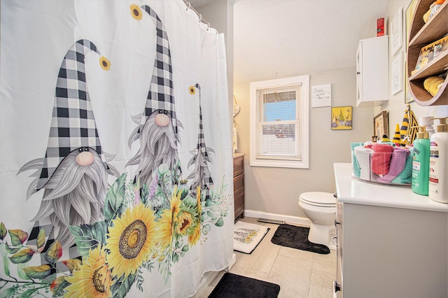 bathroom featuring tile patterned flooring, vanity, and toilet