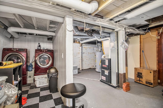 basement featuring washer and clothes dryer, gas water heater, and heating unit